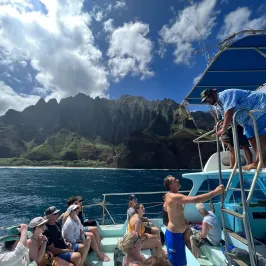 a group of people in a boat on a body of water