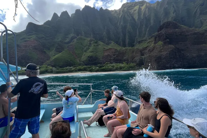 a group of people sitting on top of a mountain